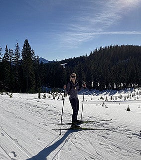 A woman wearing skis on a snowy mountain