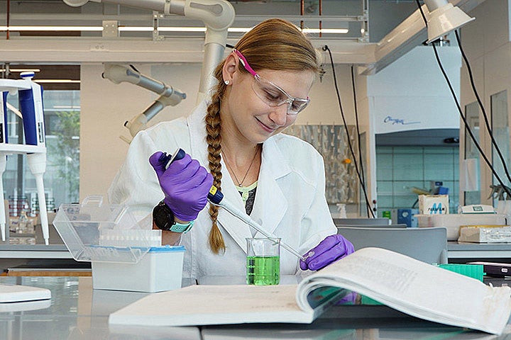 A person in a lab using scientific equipment