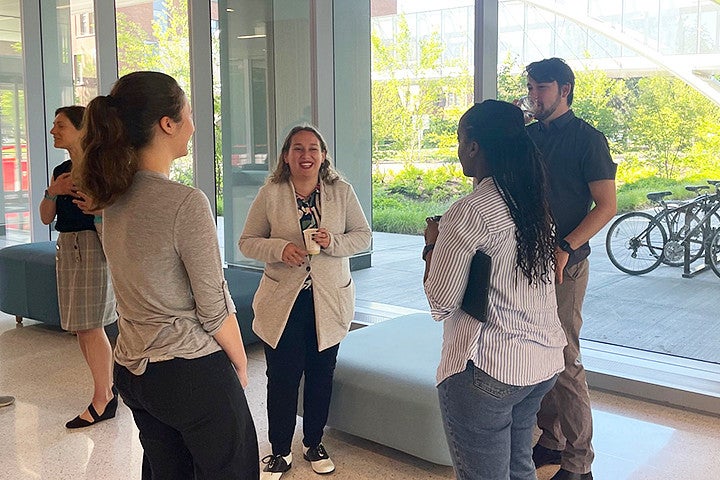 A group of people talking in a hallway