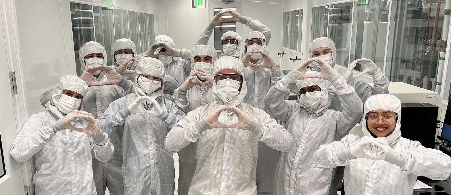 A group of people in PPE in a lab
