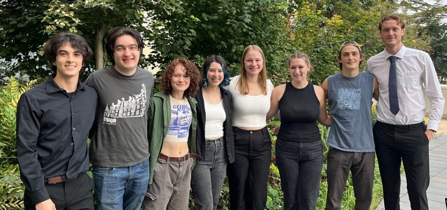 A group of college students standing on an outdoor terrace