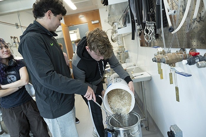 Brewing Innovation students pouring in mash