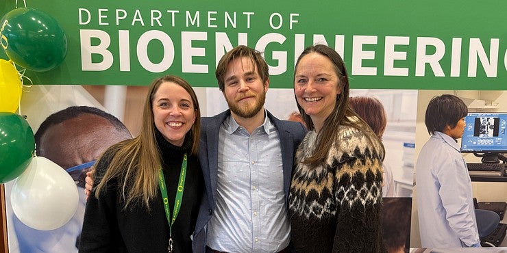 Three people in front of Department of Bioengineering backdrop