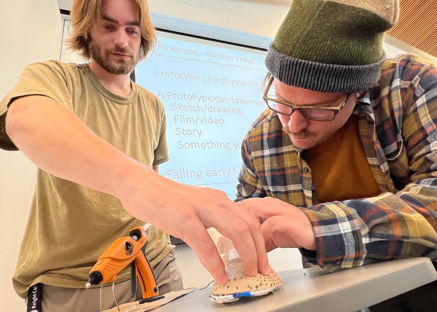 Two people working with hot glue gun