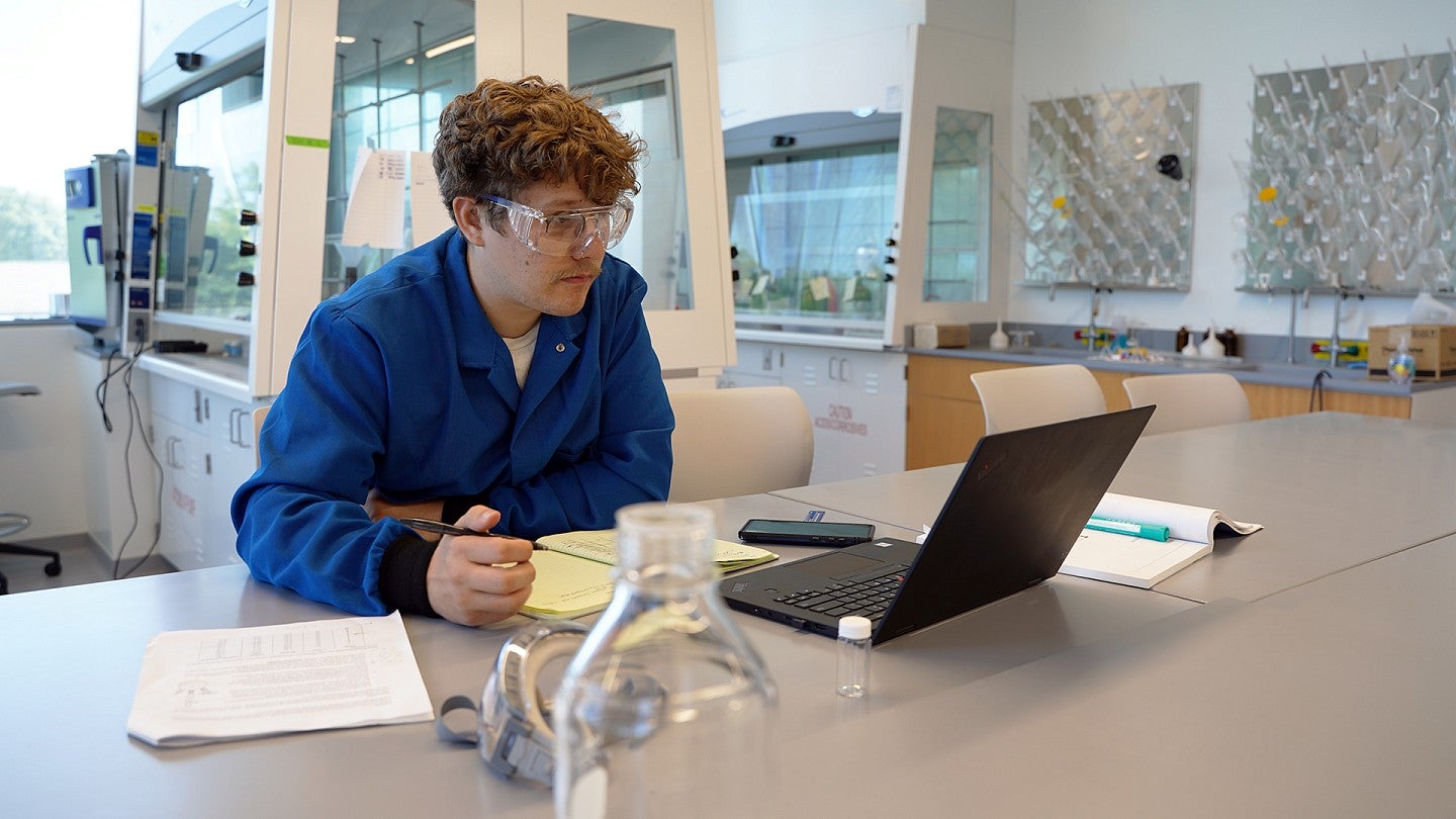 Student in the lab sitting at a laptop