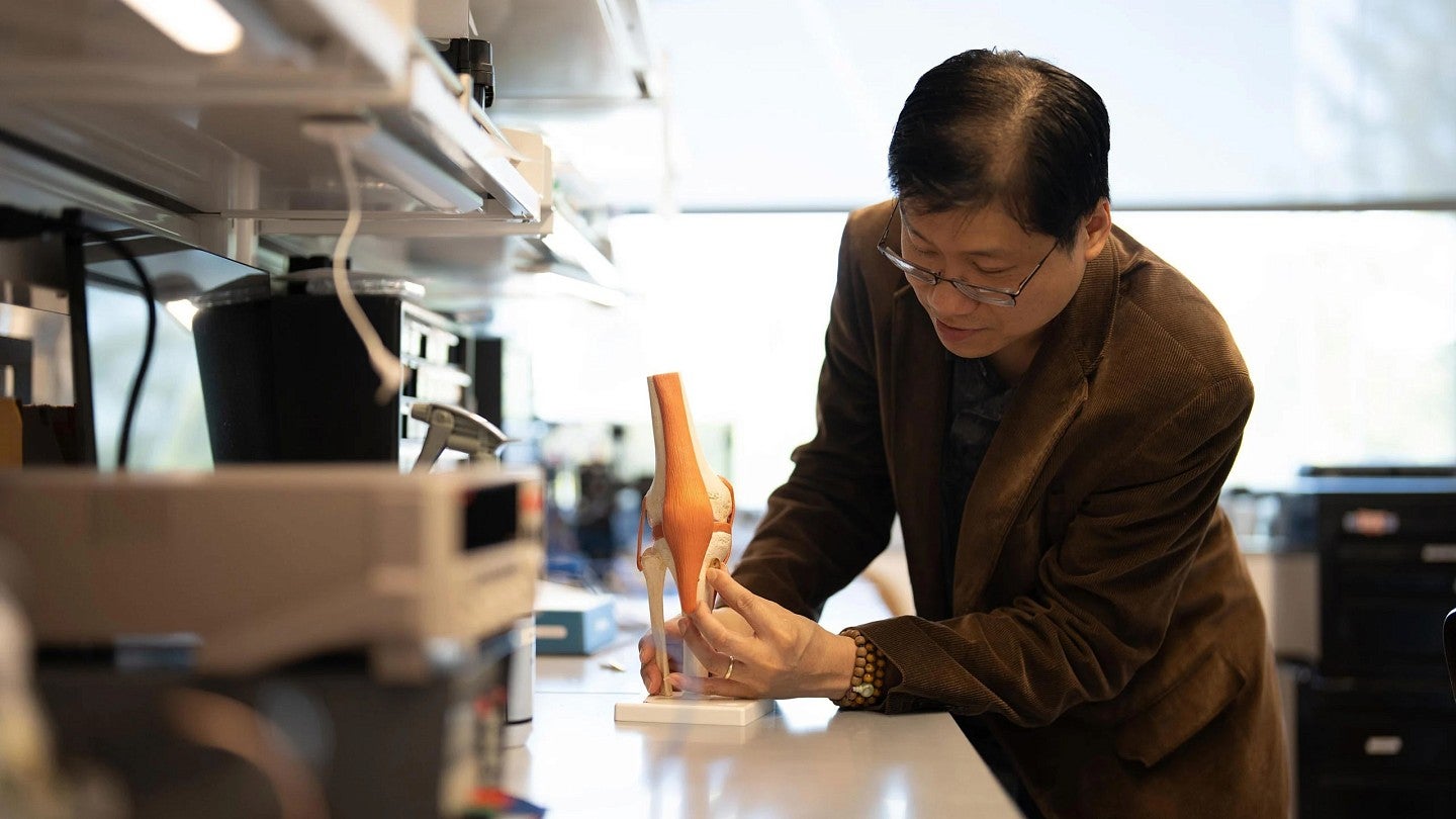 Penderia Technologies co-founder Keat "Ghee" Ong positions a sensor on a model of a knee joint.