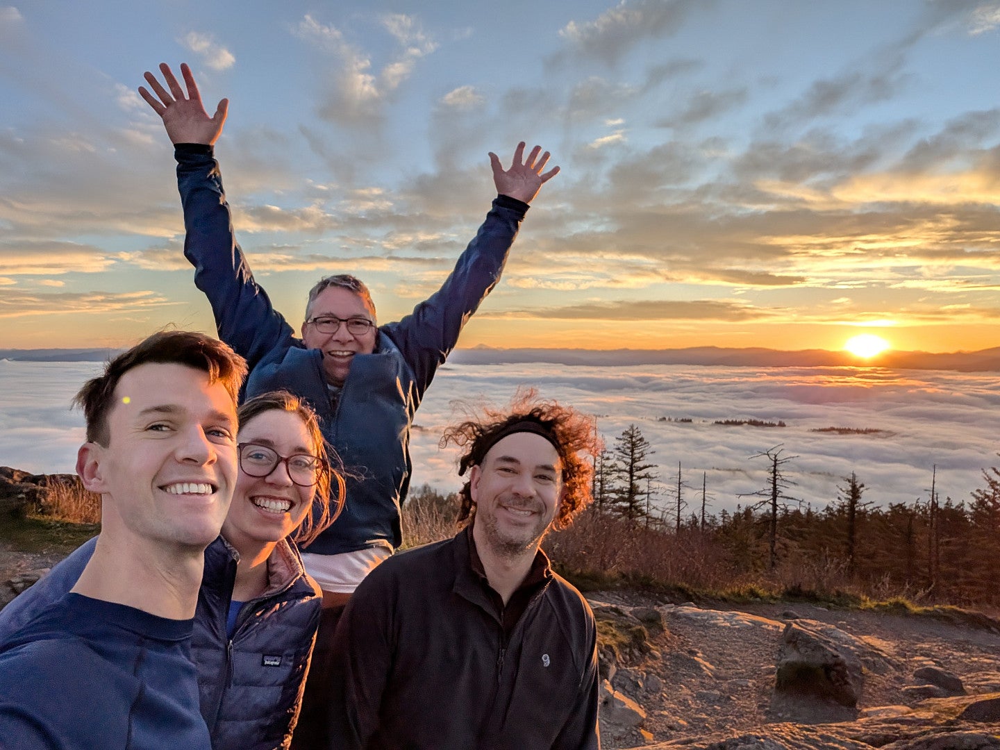 Bioengineering faculty on top of Spencer's Butte, overlooking a sunrise