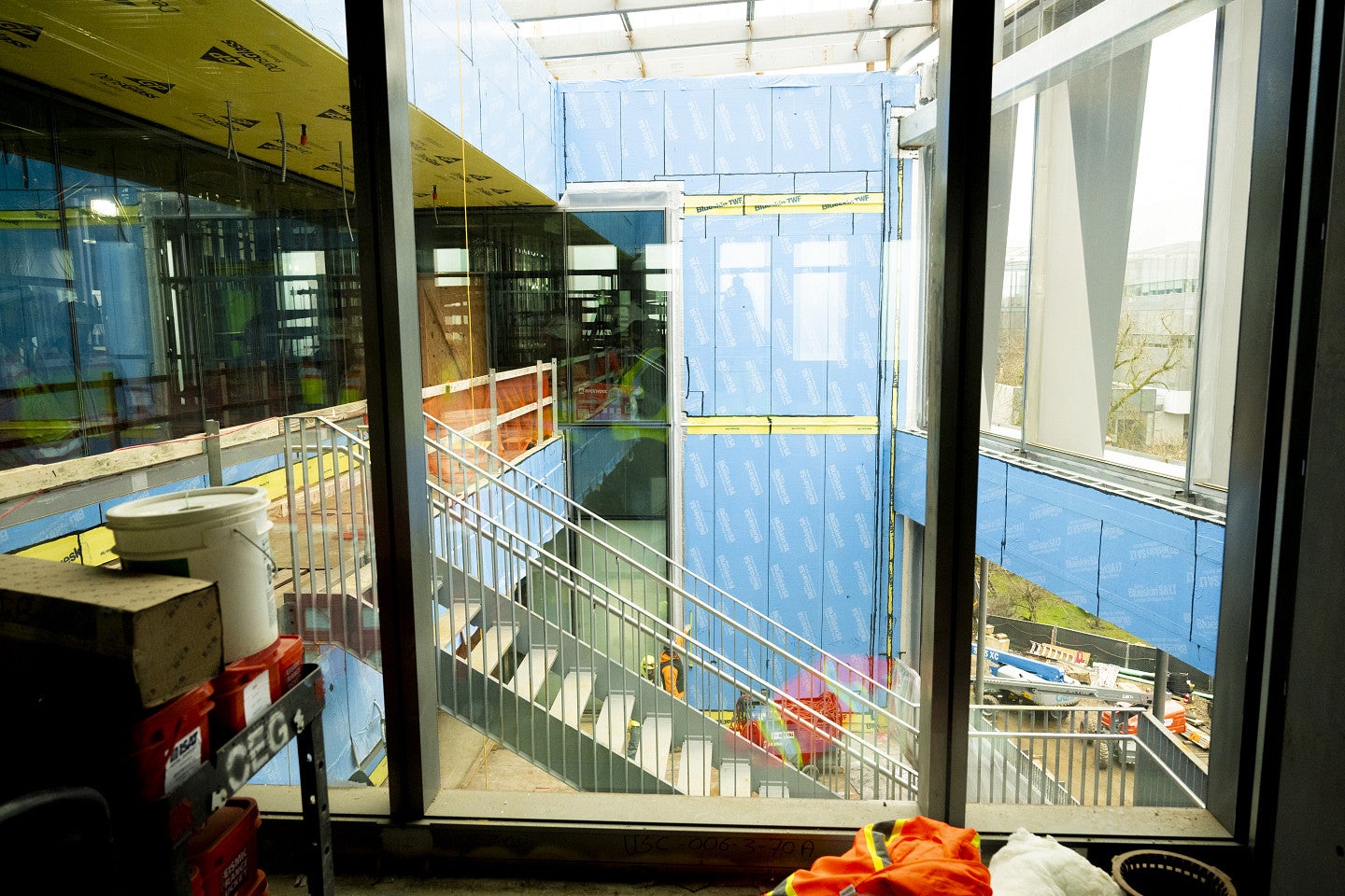 active construction site with blue and yellow paneling