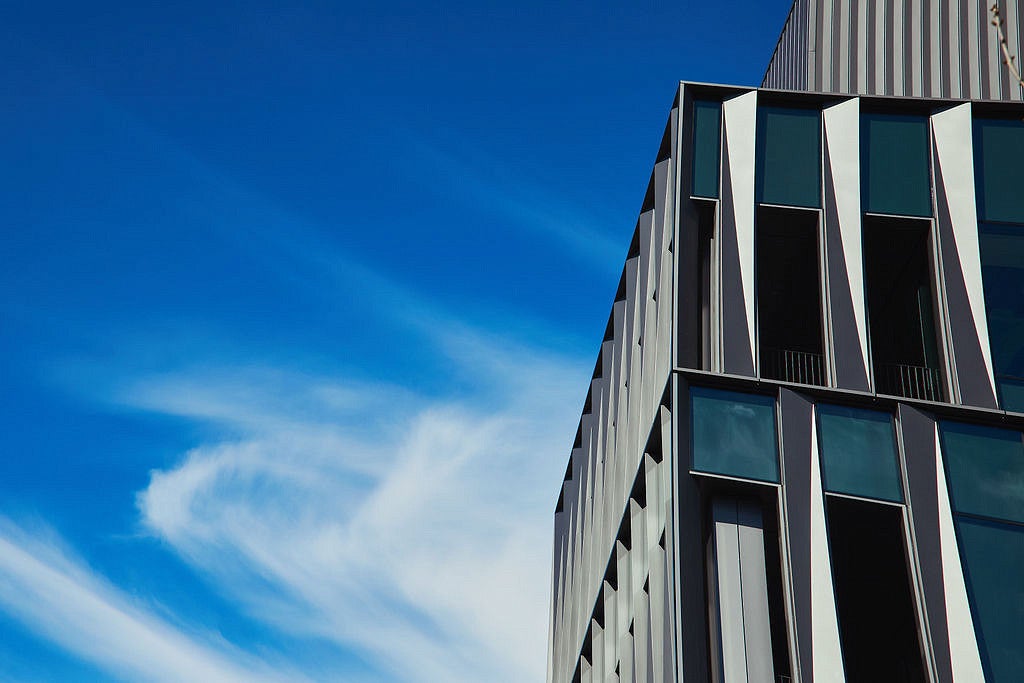Building exterior with blue sky and light clouds