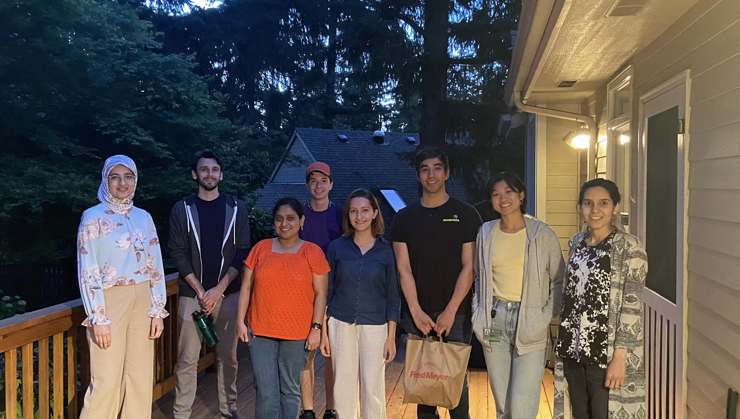 Group of people on a porch, smiling and looking at the camera