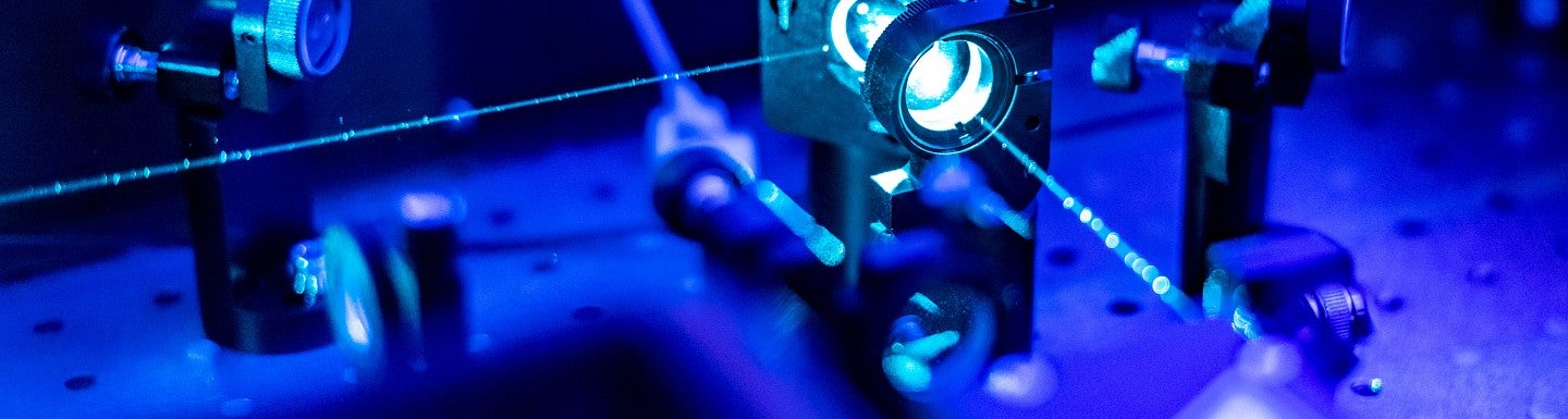 an optics table with two perpendicular laser beams