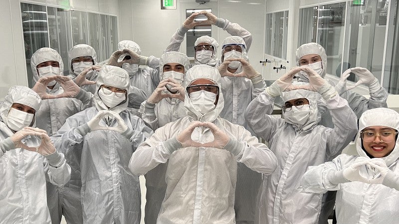A group of people in PPE in a lab