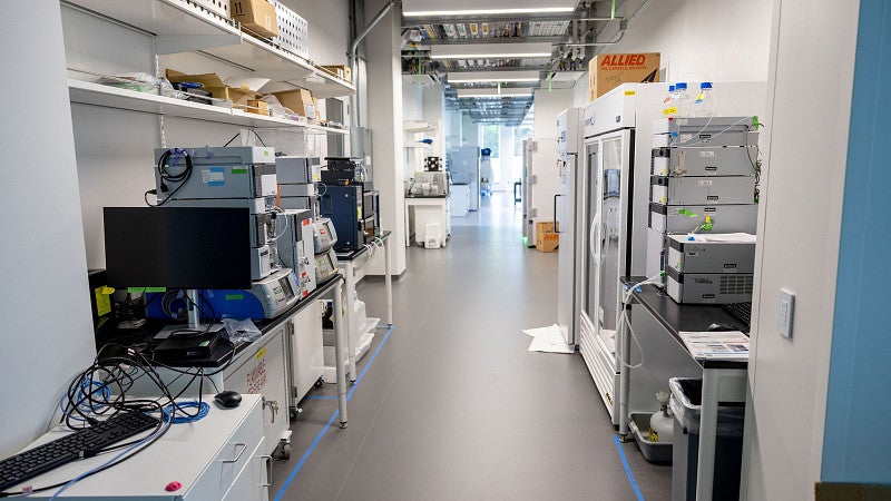 Empty lab space with equipment, with white walls, and fridges