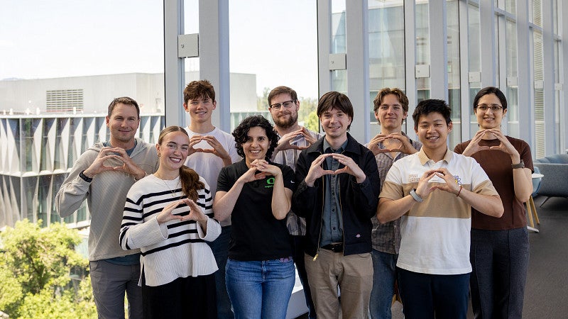 Parisa H lab photo, holding the 'O'