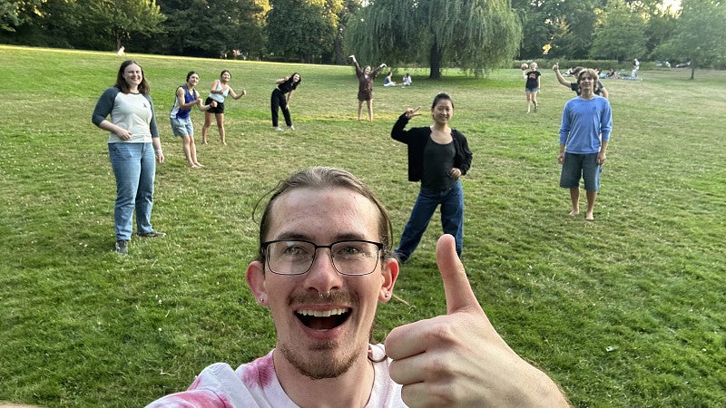 people in a park, smiling for the camera, in the summer