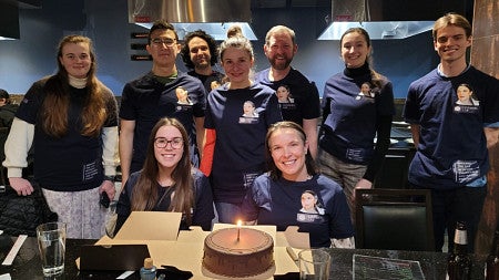 Students and faculty member in blue t shirts