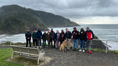 Students standing by the ocean
