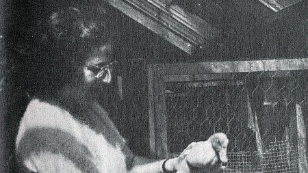 black and white image of a woman, Hildegard Lamfrom, holding a duck in her hands