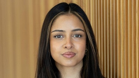 Headshot of Saumya Keremane against a wood wall