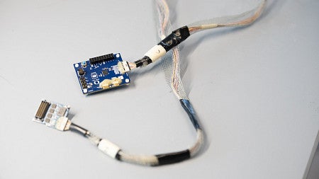 neural electrode in blue, with wires and chips