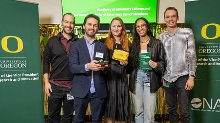 Members from the dalton lab, at the knight campus, holding a gold egg