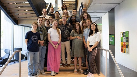 Group standing and smiling on the staircase