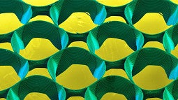 Cell Spheroid scientific image of micro-3d printed structure in yellow and green colors