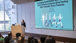 Williams at the podium for the introduction of her thesis defense cropped