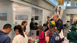 families enjoy the 3D printers in the basement of the knight campus