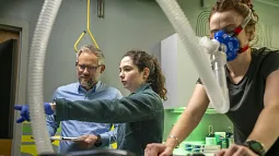 Brad Wilkins and Mira Schoeberlein collecting data from an athlete in the lab