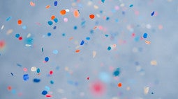 Confetti, a red, blue, orange and white dots, with a light blue background. 