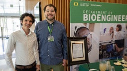 Andrew and Calin in front of the Bioengineering banner
