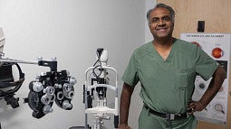 Man in scrubs smiling