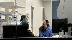 People in lab discussing work