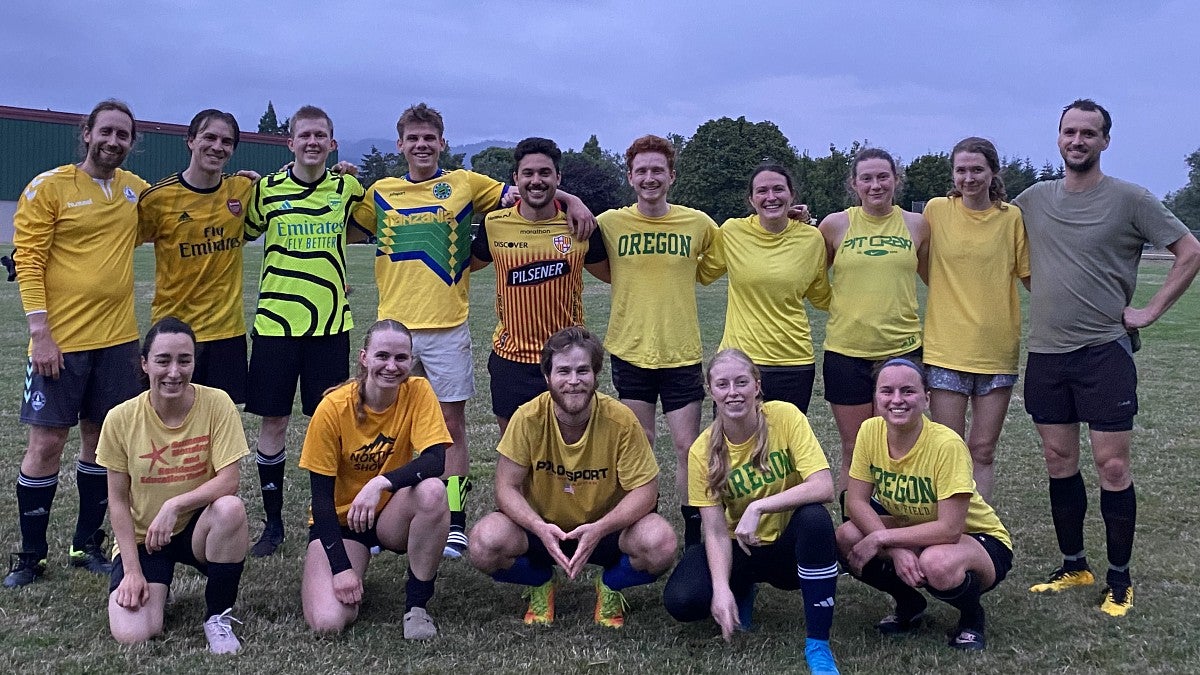 Knight Campus graduate students posing in a group wearing soccer gear