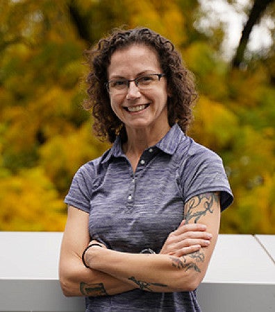 A smiling woman standing outside