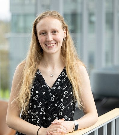 Headshot of a woman with blonde hair with a black top