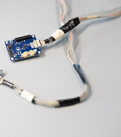 neural electrode in blue, with wires and chips