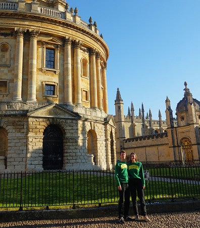 David Peeler and Sara Keller in Oregon sweatshirts in front of a building in Oxford