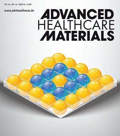 a gray background with yellow and blue spheres, in a box-like container. spheres contain bubbles, or cells. 