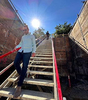 Two men walking down construction stairs