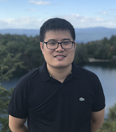Headshot of Thien Nguyen outside in a black polo