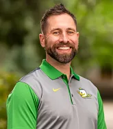 headshot of a man in a oregon duck polo